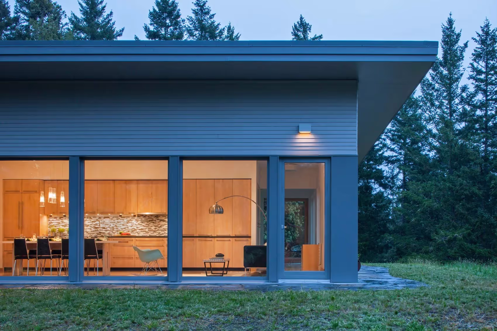 Zola fixed windows on a home exterior at dusk