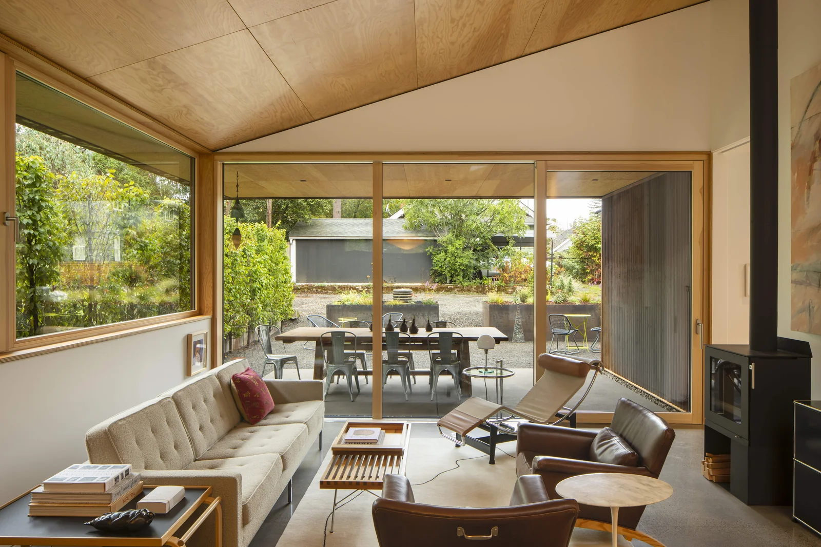Ford House living room, clad wood sliding doors open to the garden and dining terrace