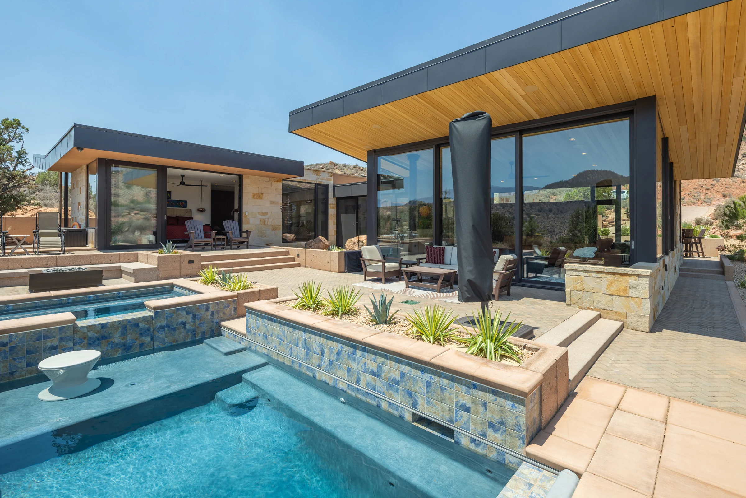 The Show — a poolside terrace under a cantilevered roof in the red rock desert, Springdale, Utah