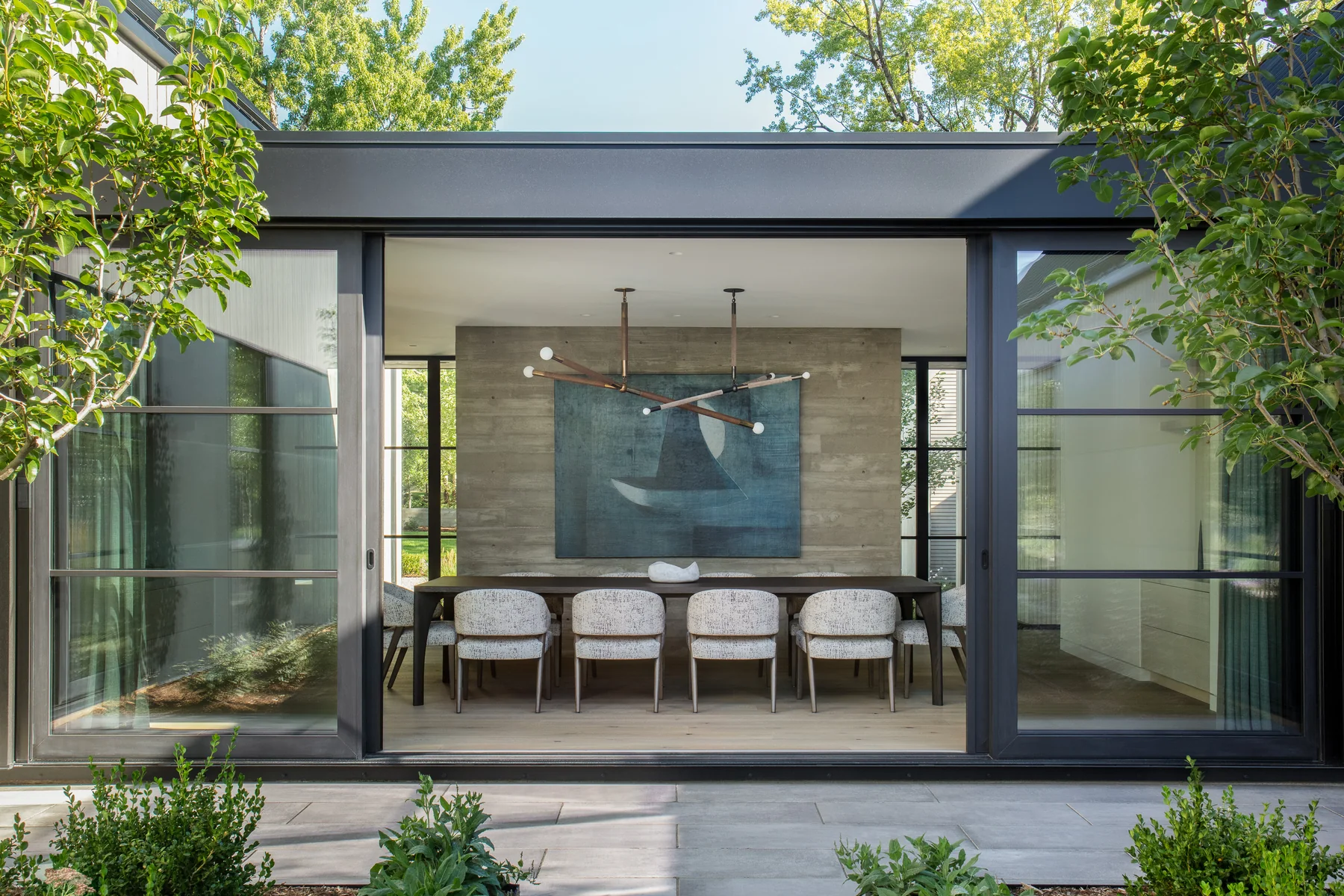 A Linden Grove dining room opened to the garden through a wide aluminum sliding door