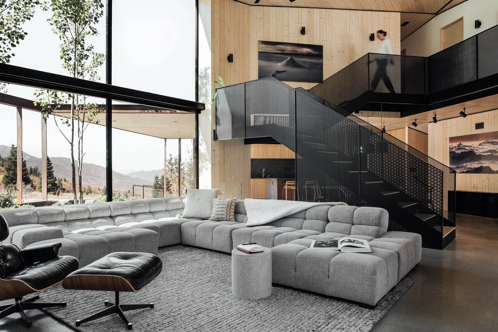 Powder Haus living room under a double-height aluminum window wall looking to the Wasatch