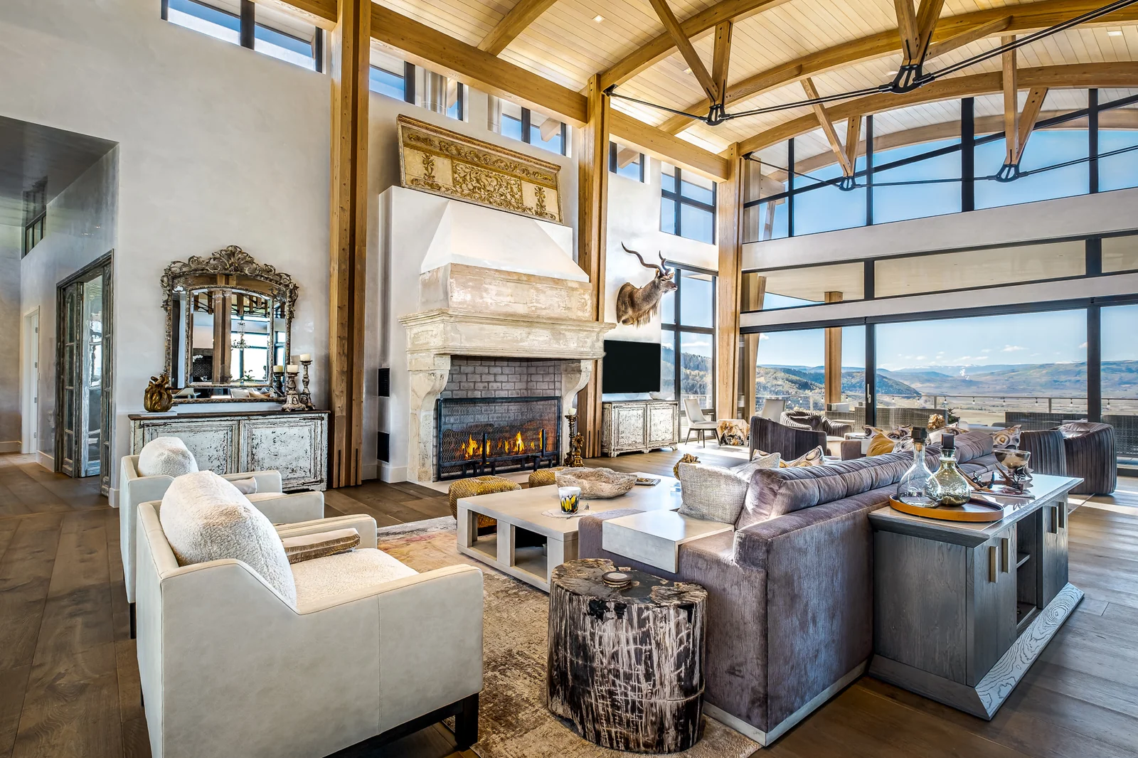 Yampa Overlook great room — timber trusses and a glazed wall over the valley